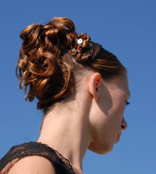 young woman and her beautiful hairstyle for ceremony