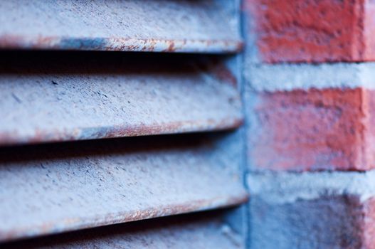 Clous up vent grate with red brick wall