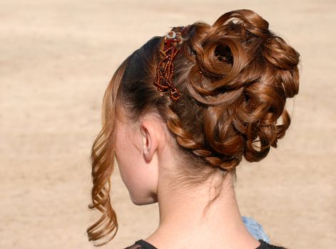 young woman and her beautiful hairstyle for ceremony