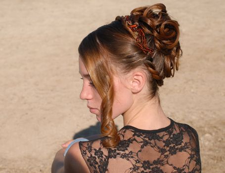 young woman and her beautiful hairstyle for ceremony 