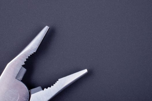 Close up pliers on a black background