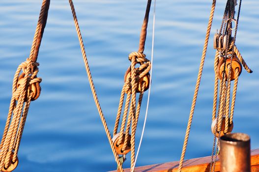 Sail yacht ropes and blocks on a water background