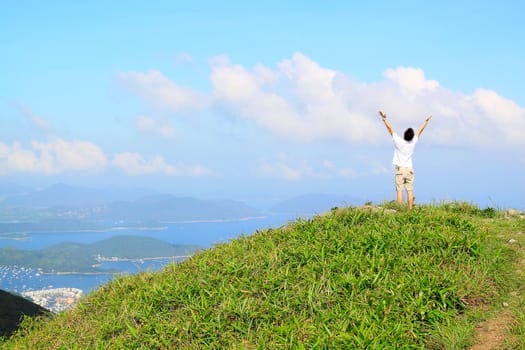 Beautiful mountains landscape with lake in hongkong and man on the top 