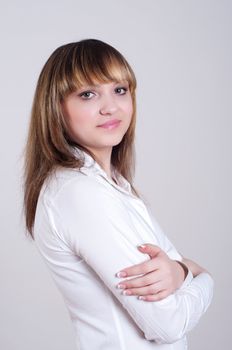 portrait of a beautiful woman in a white blouse with a gray background