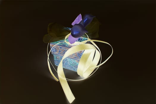 nice image with beautiful flowers and shiny ribbon on magic box 