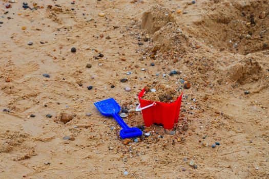 childs bucket and spade by sea