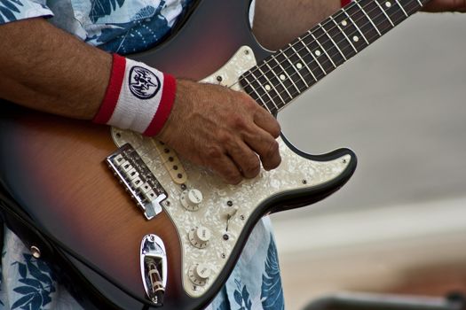 Six string guitar been played by unknow musician.