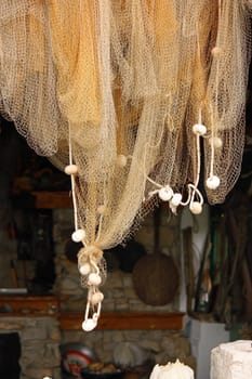 Fishing net hanging in front of the old kitchen