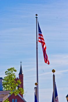 A single American flag stands high amongst church steeples.