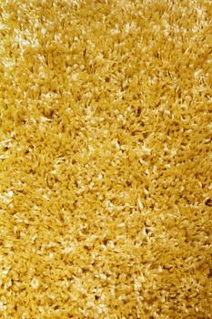yellow carpet of artificial material close-up. The texture of the carpet