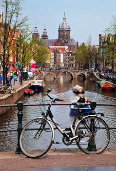 Amsterdam, Holland, Netherlands. Church of St Nicholas, old town canal, boats, bike