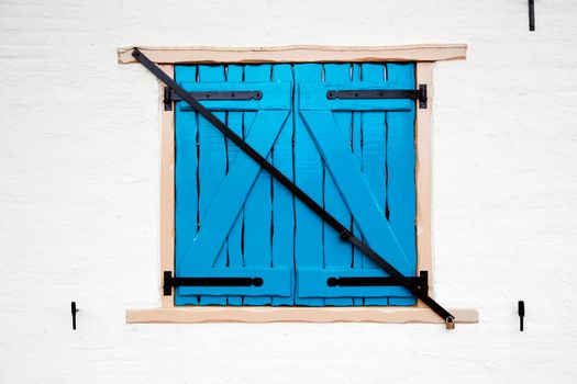 Old retro window with shutters on white painted house. Netherlands