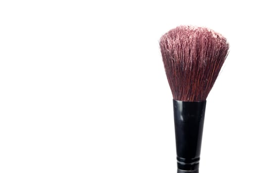 A blush brush with powder isolated on a white background.