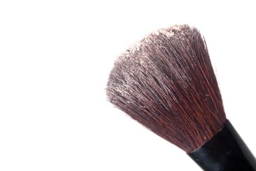 A blush brush with powder isolated on a white background.