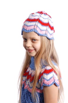 smiling little girl in knitted hat on a white background