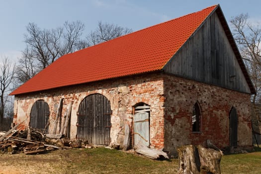old brick barn with red tile roof