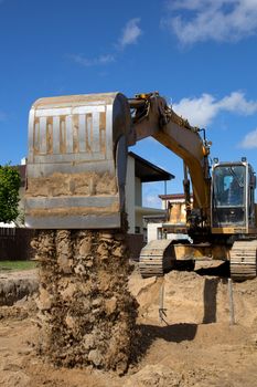 excavator loader machine during earthmoving works outdoors at construction site