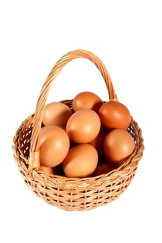 brown eggs in wicker basket on a white background