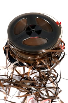 stack of old magnetic tapes on white