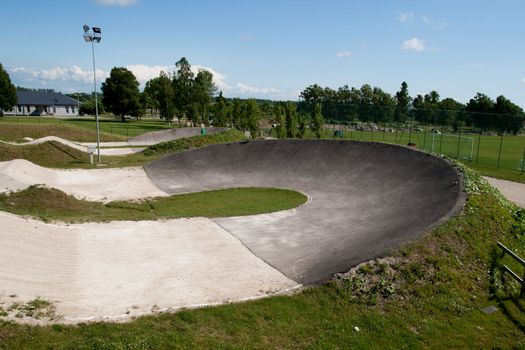 empty bmx track curve in sunny summer day