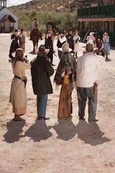 Dangerous gunfight outside in old American west scene