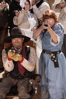 Armed older man and woman in historic American west costumes