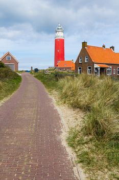 Beautiful red Lighthouse with road, island Texsel, Netherlands. Vertical view