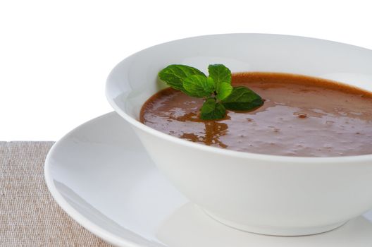 Chocolate mousse ou a white mug with mint leaves.