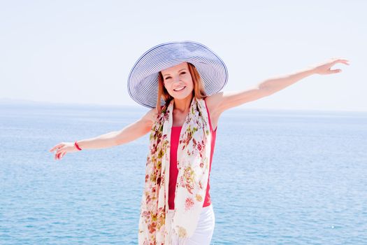 Young and beautiful girl resting on rocks against the sea