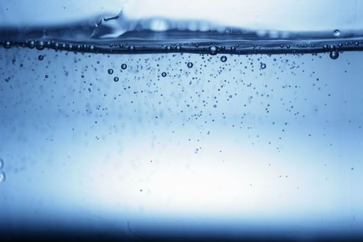 close up of water bubbles in a glass