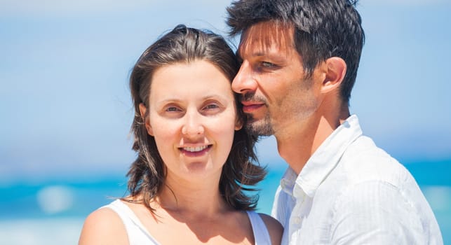 Portrait of a romantic happy young couple together on the beach