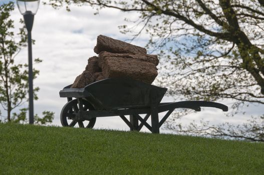 landscape with wheelbarrow with peat