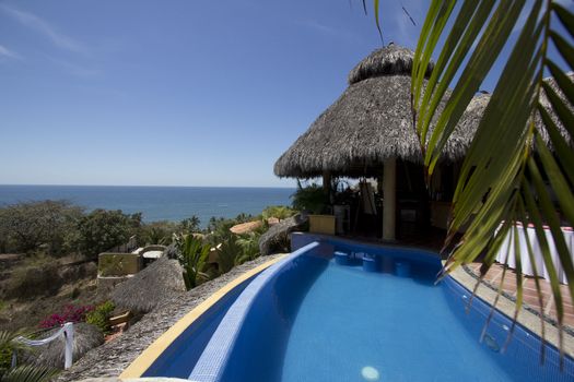 Mexican villa with beach view and a swimming pool.