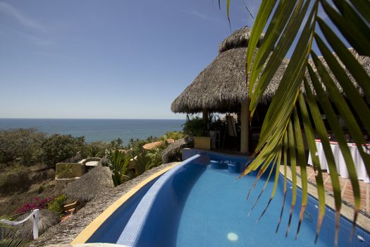 Mexican villa with beach view and a swimming pool.