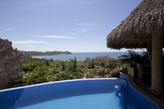 Mexican villa with beach view and a swimming pool.