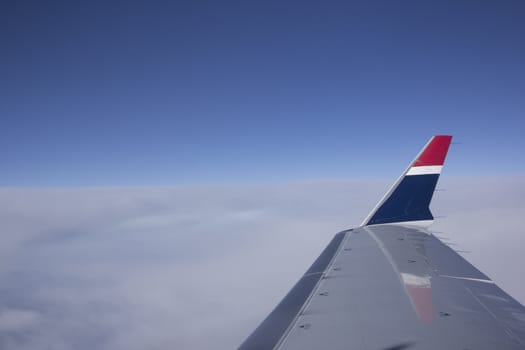 Shot of a Boeing 737 wing at cruising altitude over clouds