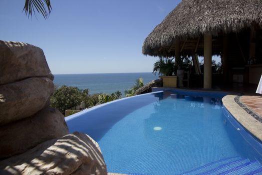 Mexican villa with beach view and a swimming pool.