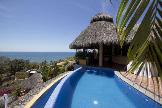 Mexican villa with beach view and a swimming pool.