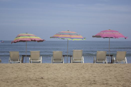 beach with chairs and umbrellas