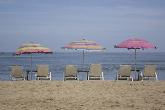 beach with chairs and umbrellas