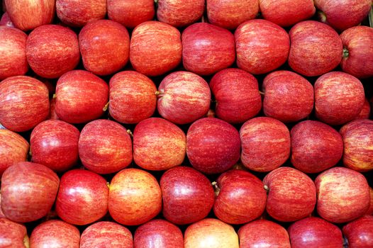 Apples neatly stacked in rows on farm stand