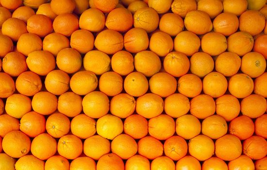 Orange citrus fruit background stacked neatly in rows