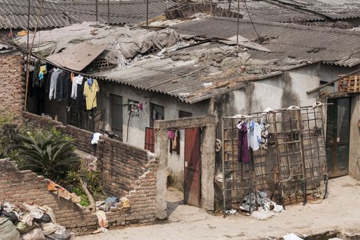 Laundry dries in the wind outside the slum.