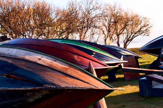 Bottoms of drying wooden boats during restoration