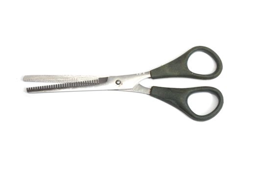 Jagged edges hairdressing scissors. Isolated over white 