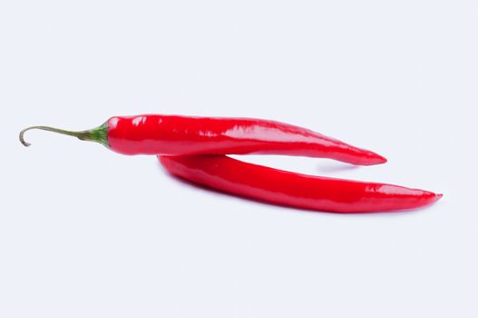Two chili peppers in the white background