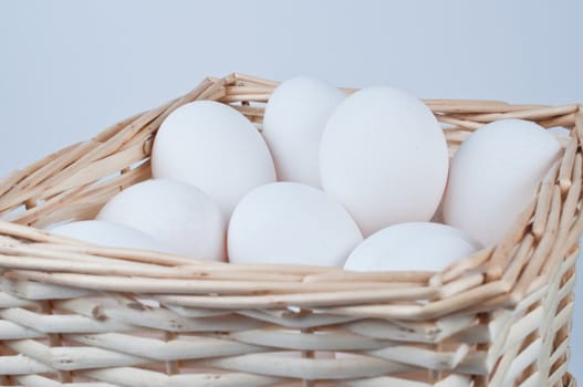 Basket full of  chicken eggs on white background