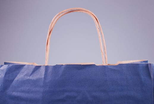 Paper bag with a handles fragment on purple