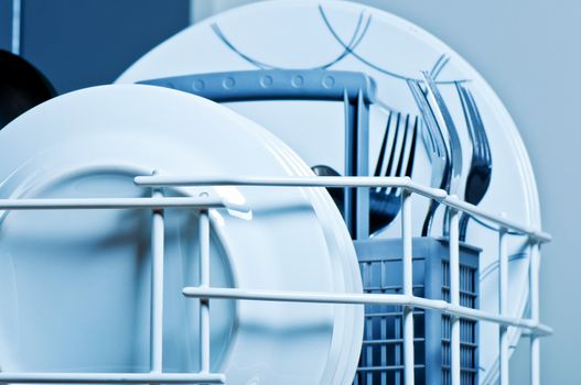 Plates and forks inside  dishwasher