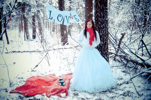 Winter snow forest with girl in red scarf.